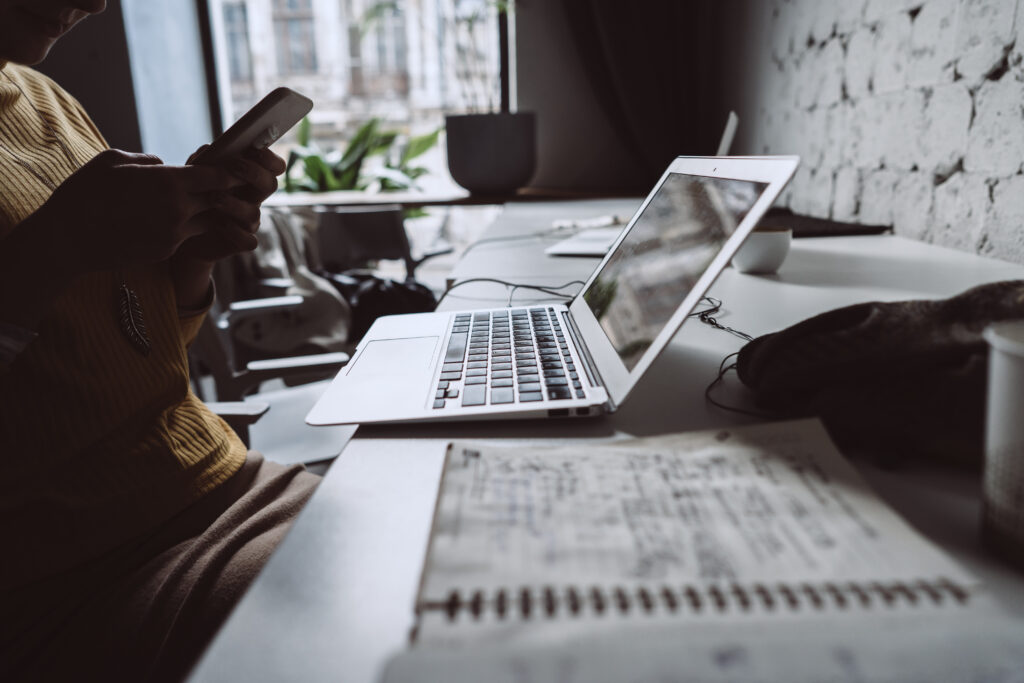 young woman sitting at office table with laptop.